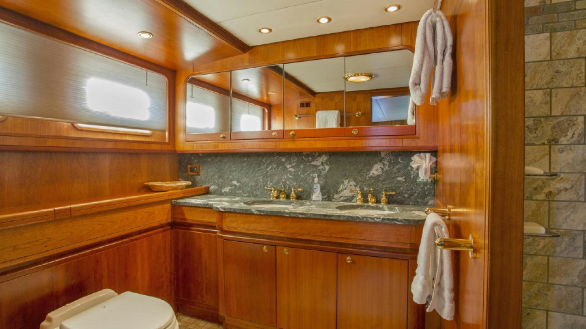 a kitchen with wooden cabinets aboard MYU Yacht for Sale