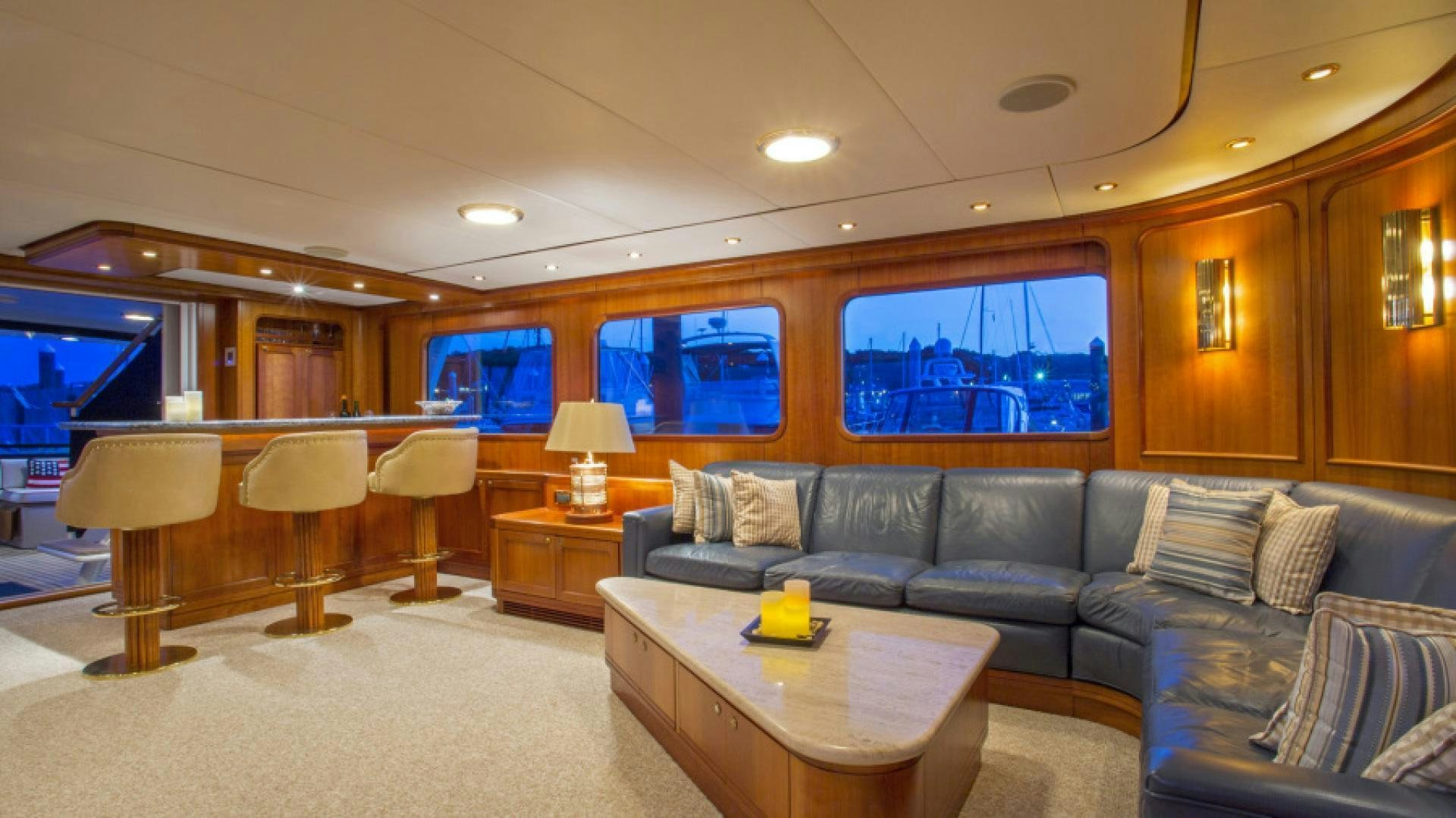 a living room with a couch and a table aboard MYU Yacht for Sale