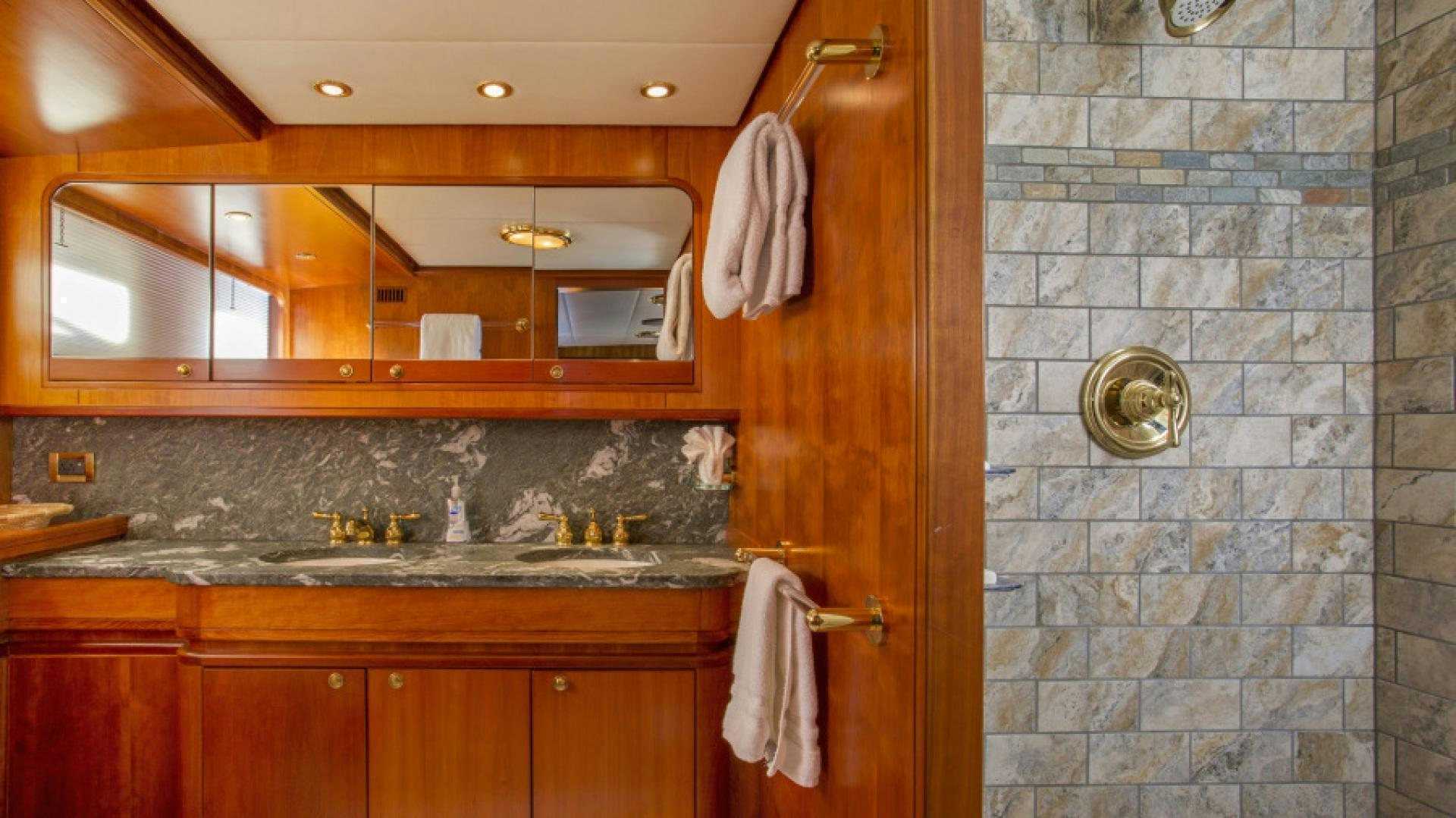 a bathroom with a sink and cabinets aboard MYU Yacht for Sale