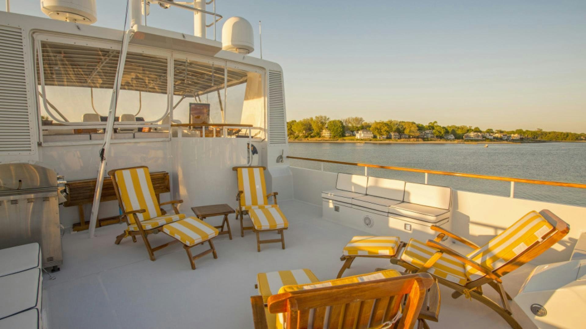 a deck with chairs and tables aboard MYU Yacht for Sale