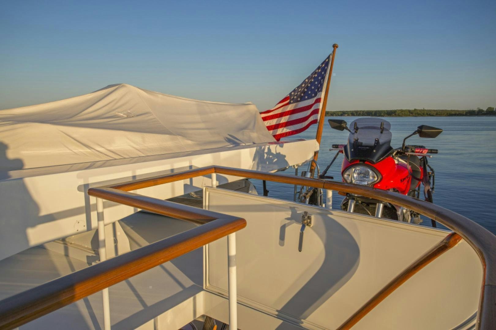 a boat with a red and white flag on the front aboard MYU Yacht for Sale