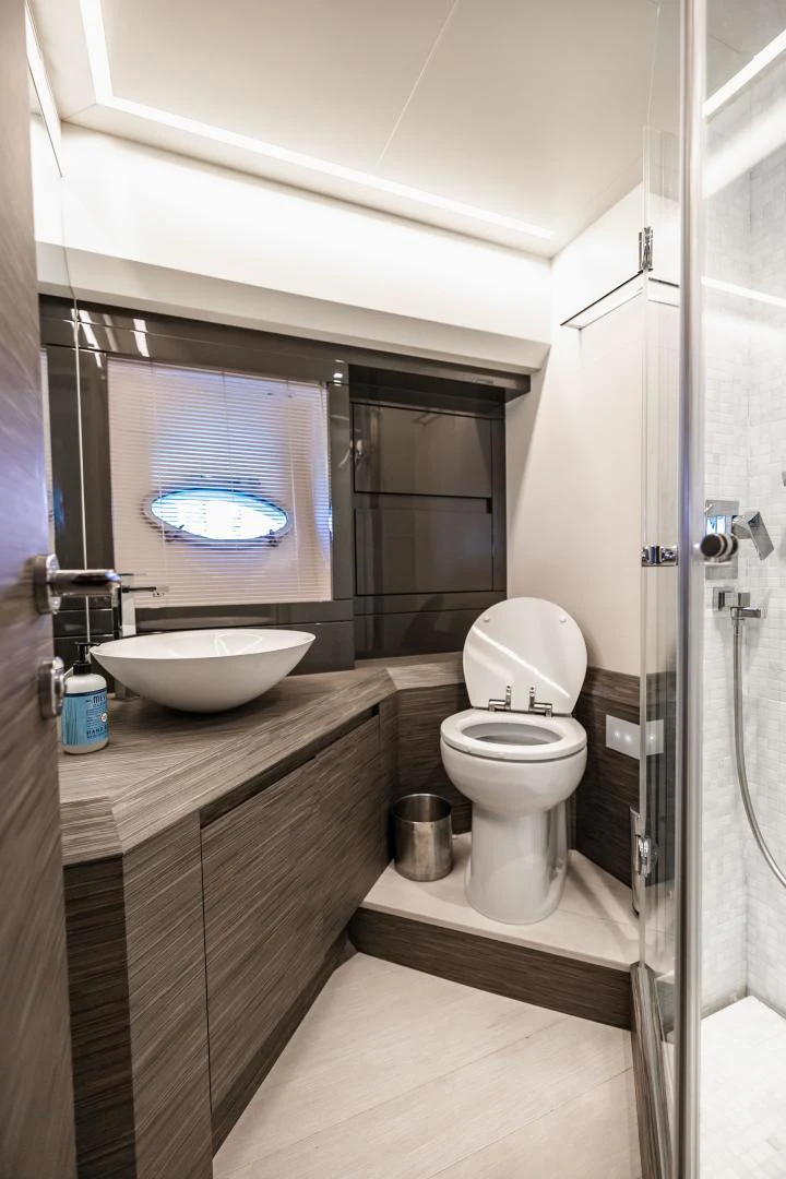 a bathroom with a sink toilet and a window aboard DOUBLE OR NOTHING Yacht for Sale