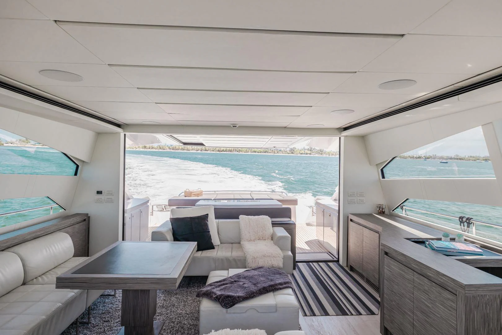a room with a couch and a table and a window aboard DOUBLE OR NOTHING Yacht for Sale