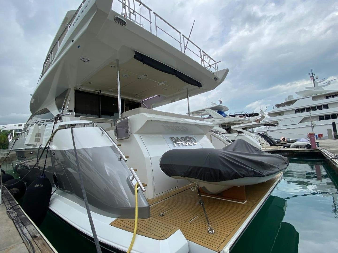 a boat docked at a pier aboard PASEO Yacht for Sale