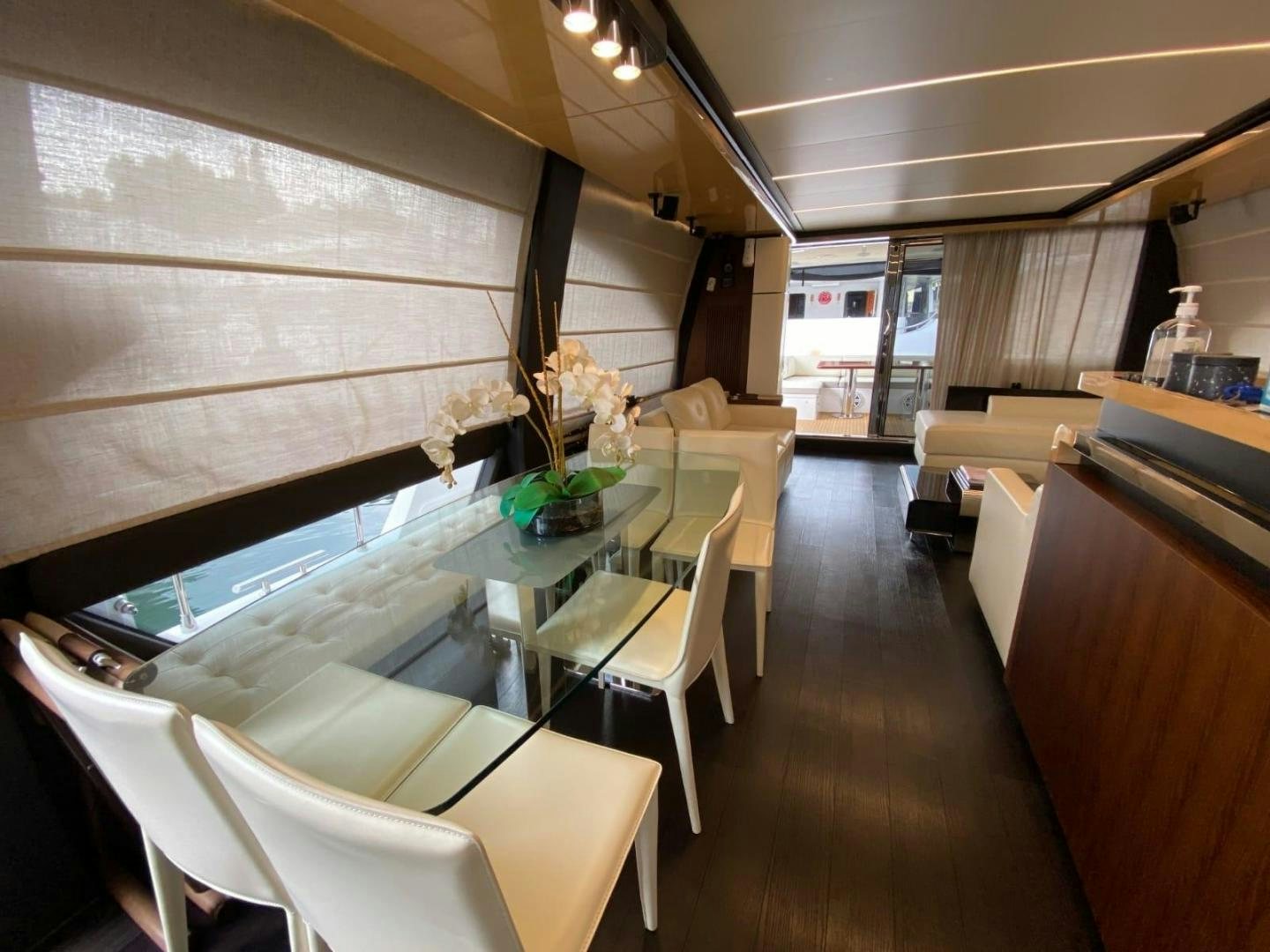 a room with a table chairs and a window aboard PASEO Yacht for Sale