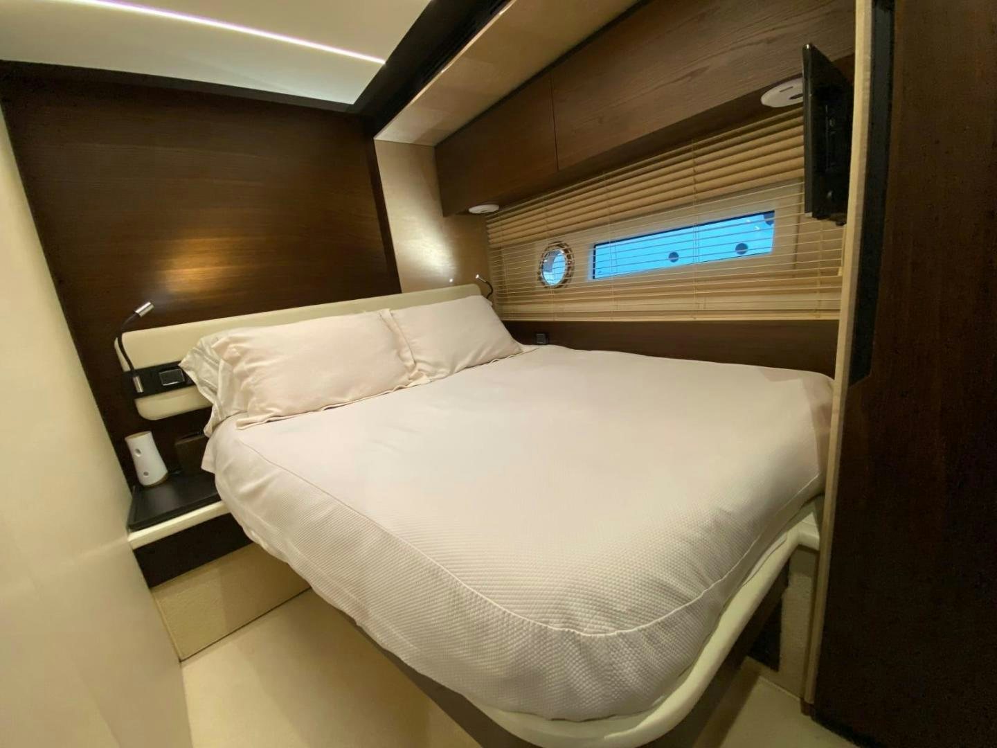 a bed with a white sheet aboard PASEO Yacht for Sale