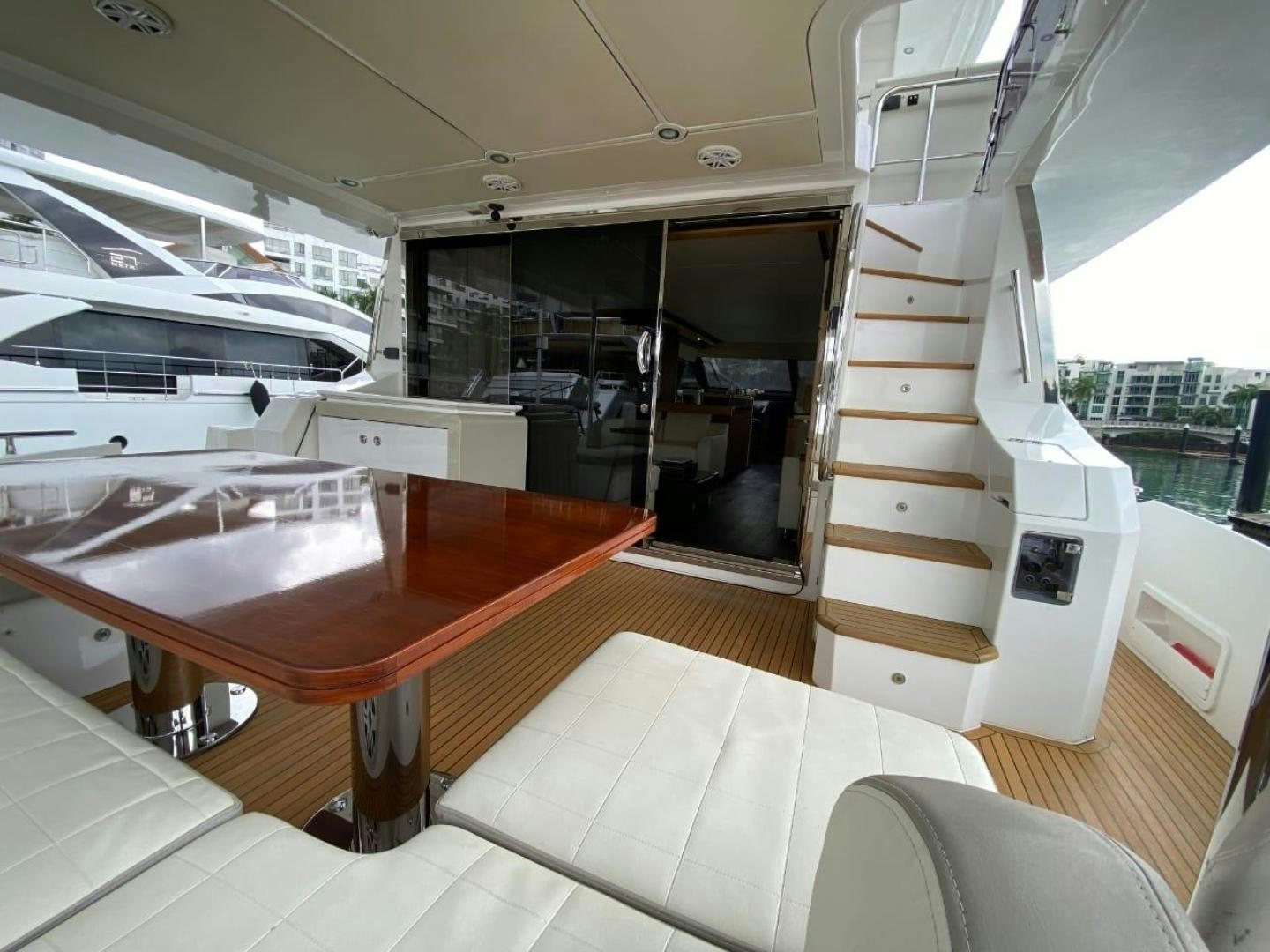 a room with a table and chairs aboard PASEO Yacht for Sale