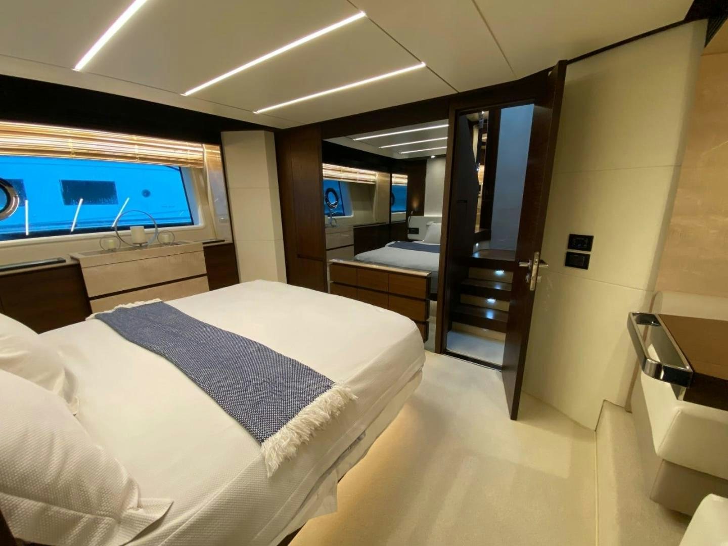 a room with a bed and a desk aboard PASEO Yacht for Sale