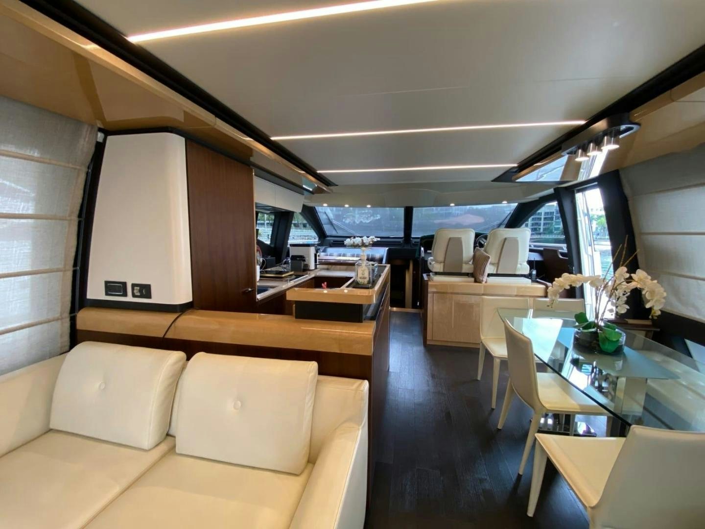 a room with a couch and a table aboard PASEO Yacht for Sale