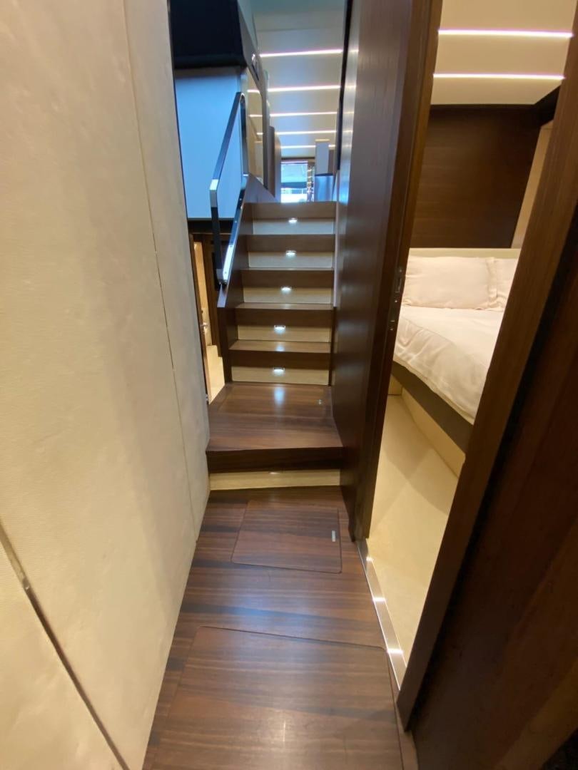 a hallway with a bed and a staircase aboard PASEO Yacht for Sale