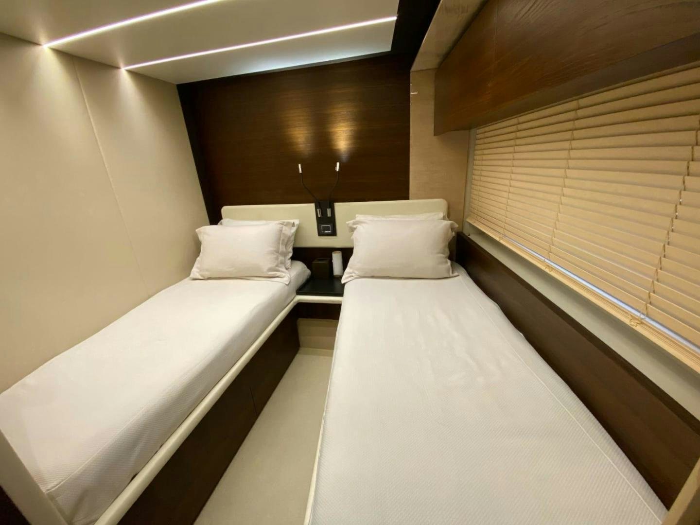 a room with two beds aboard PASEO Yacht for Sale