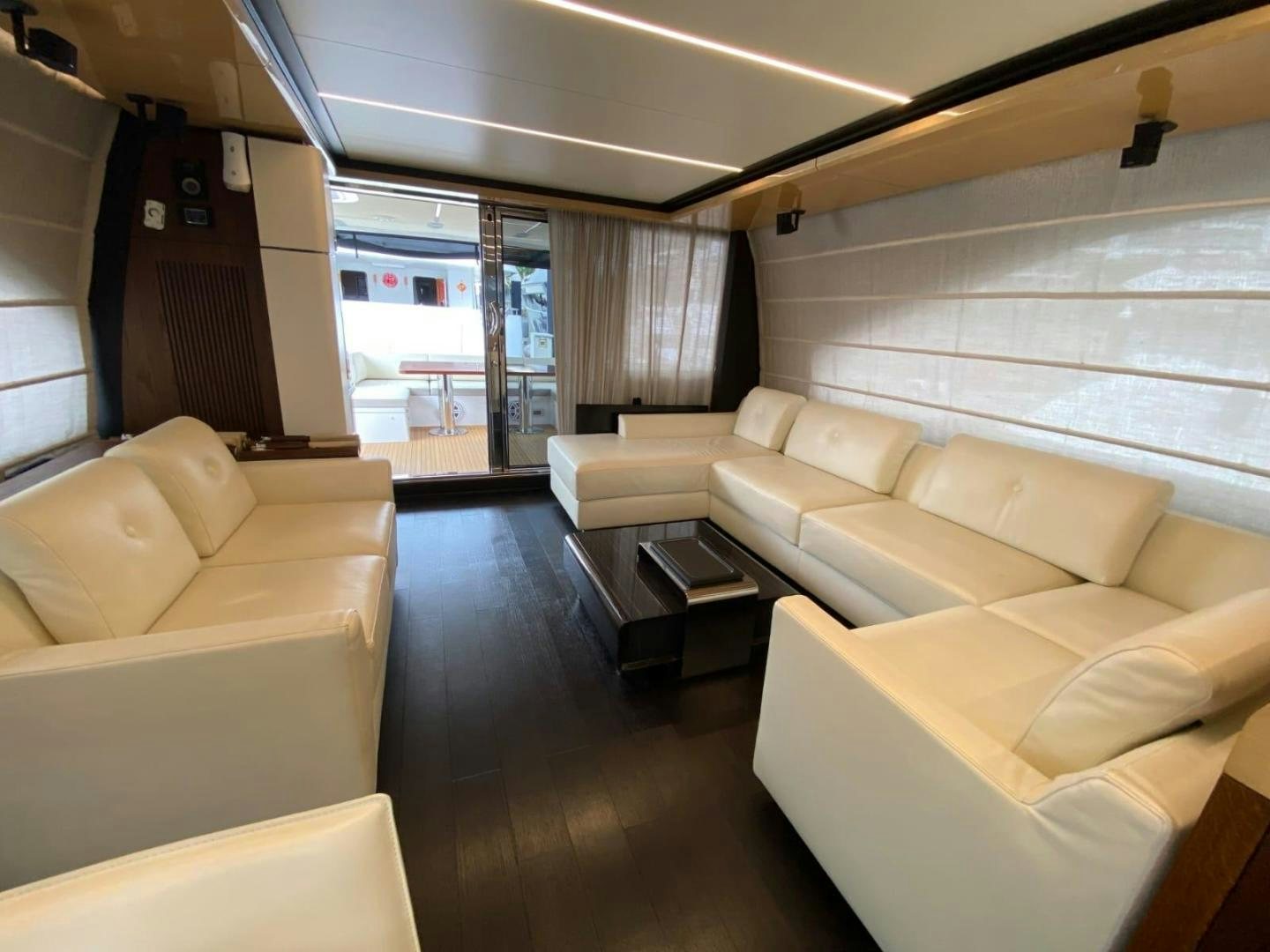 a living room with a large window aboard PASEO Yacht for Sale