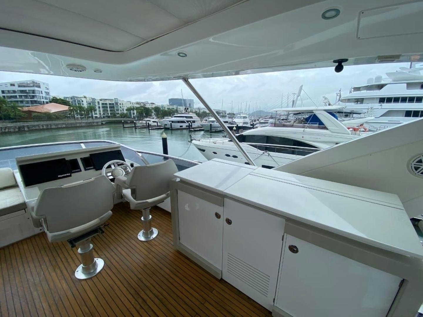 a room with a deck and chairs aboard PASEO Yacht for Sale