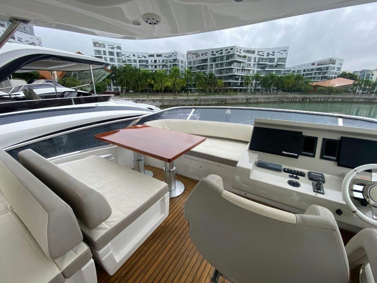 a room with a table and chairs aboard PASEO Yacht for Sale