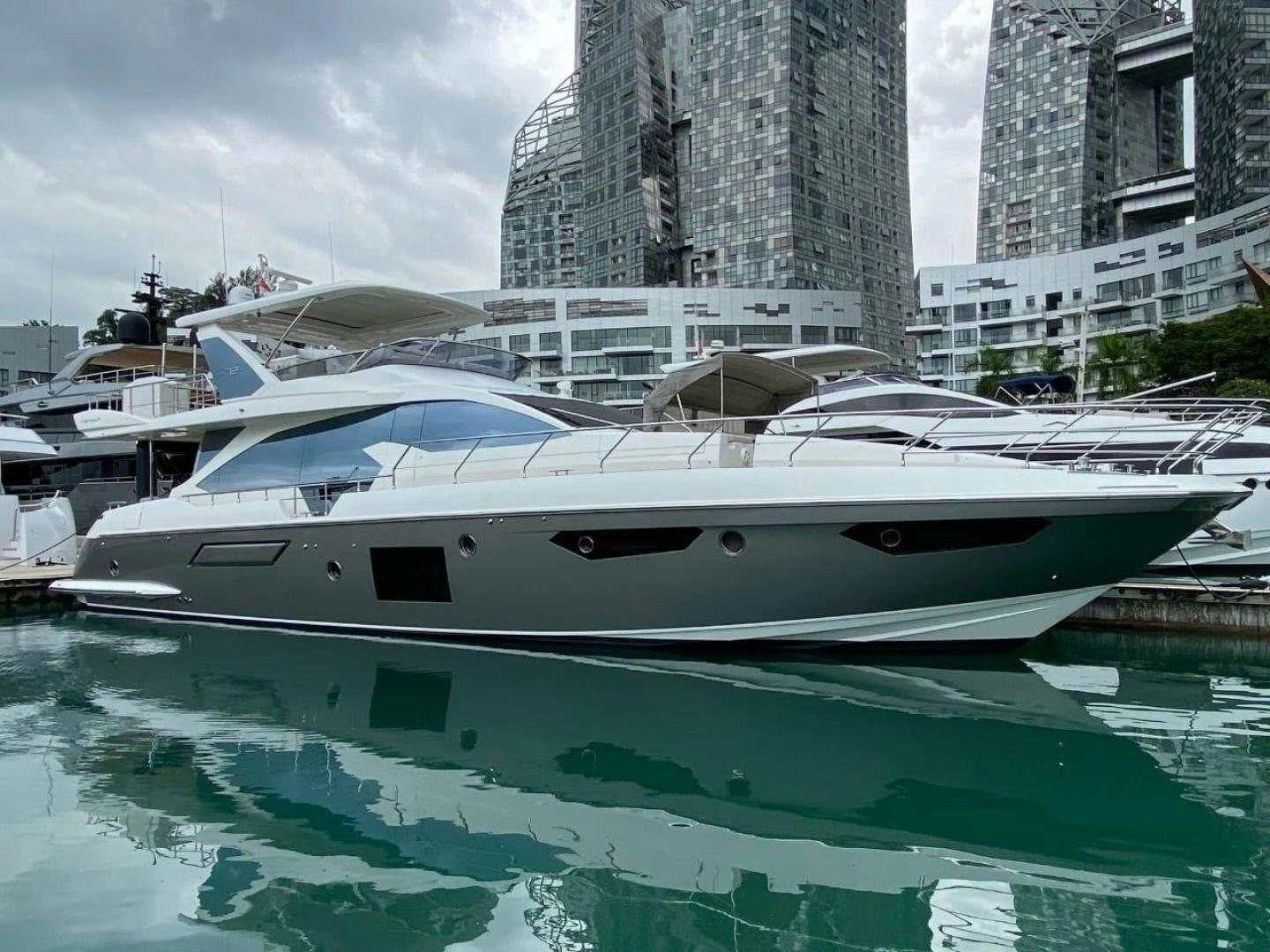 a white yacht in a harbor aboard PASEO Yacht for Sale