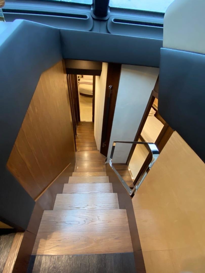 a wooden staircase in a room aboard PASEO Yacht for Sale