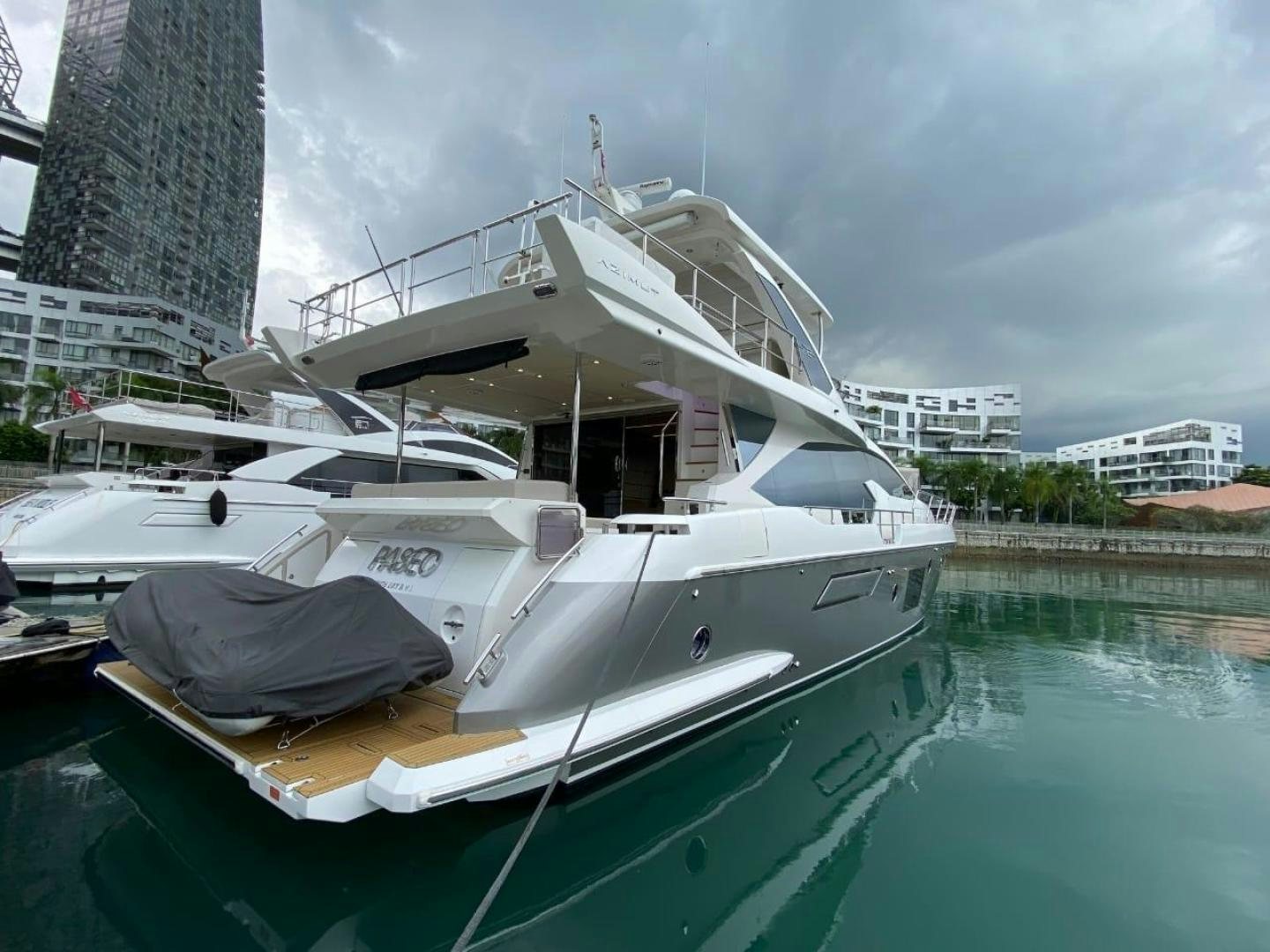 a boat docked in a harbor aboard PASEO Yacht for Sale