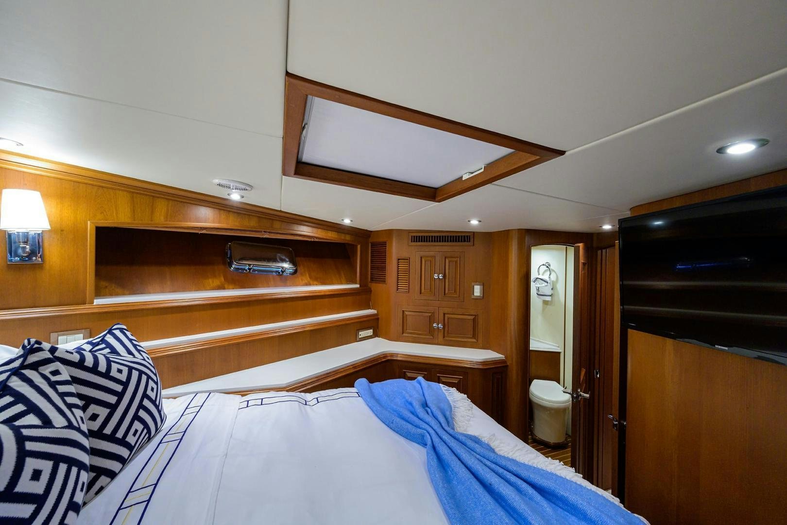 a room with a bed and a wood cabinet aboard HARD TIMES NAME RESERVED Yacht for Sale
