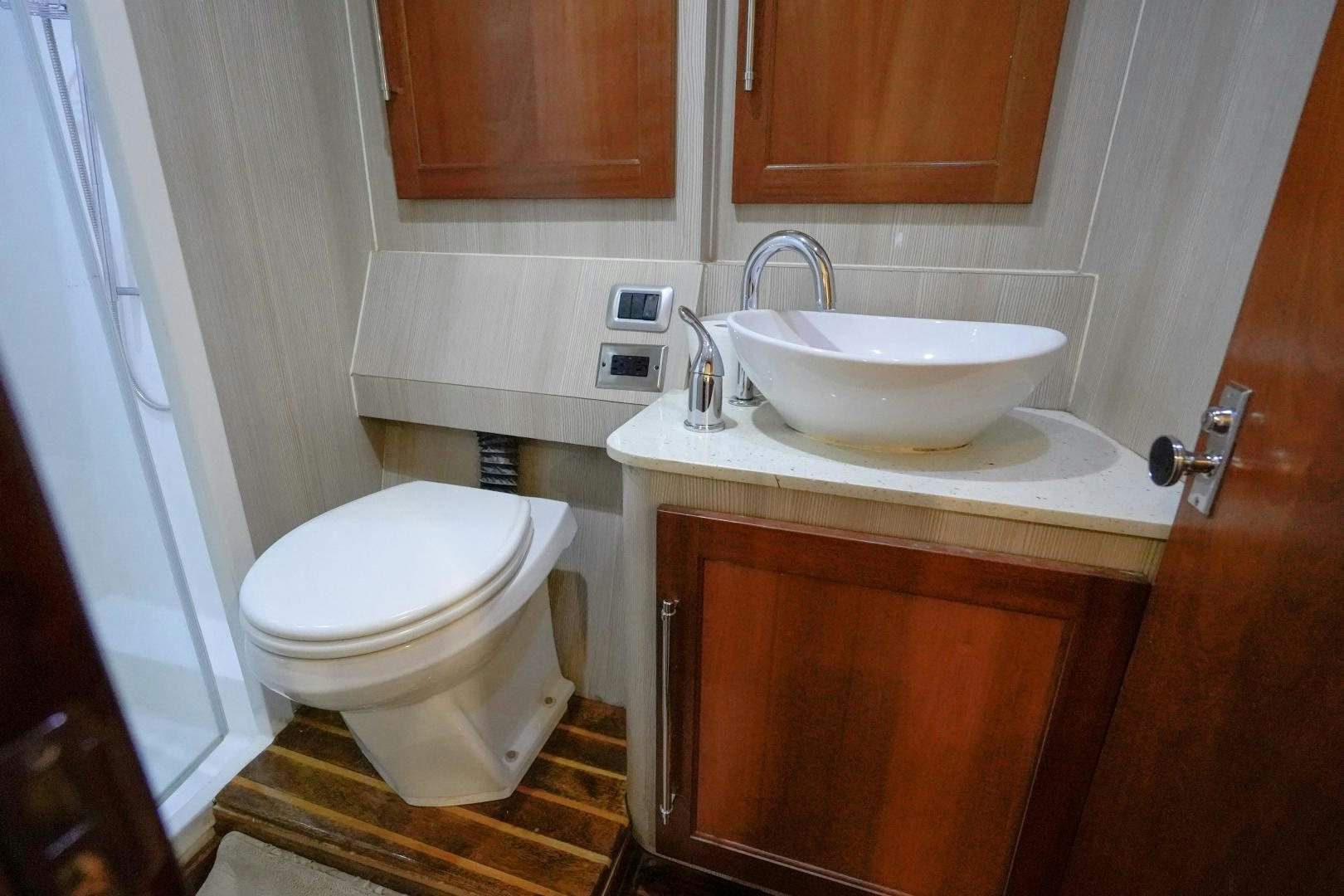a bathroom with a toilet and sink aboard BIG ENOS Yacht for Sale