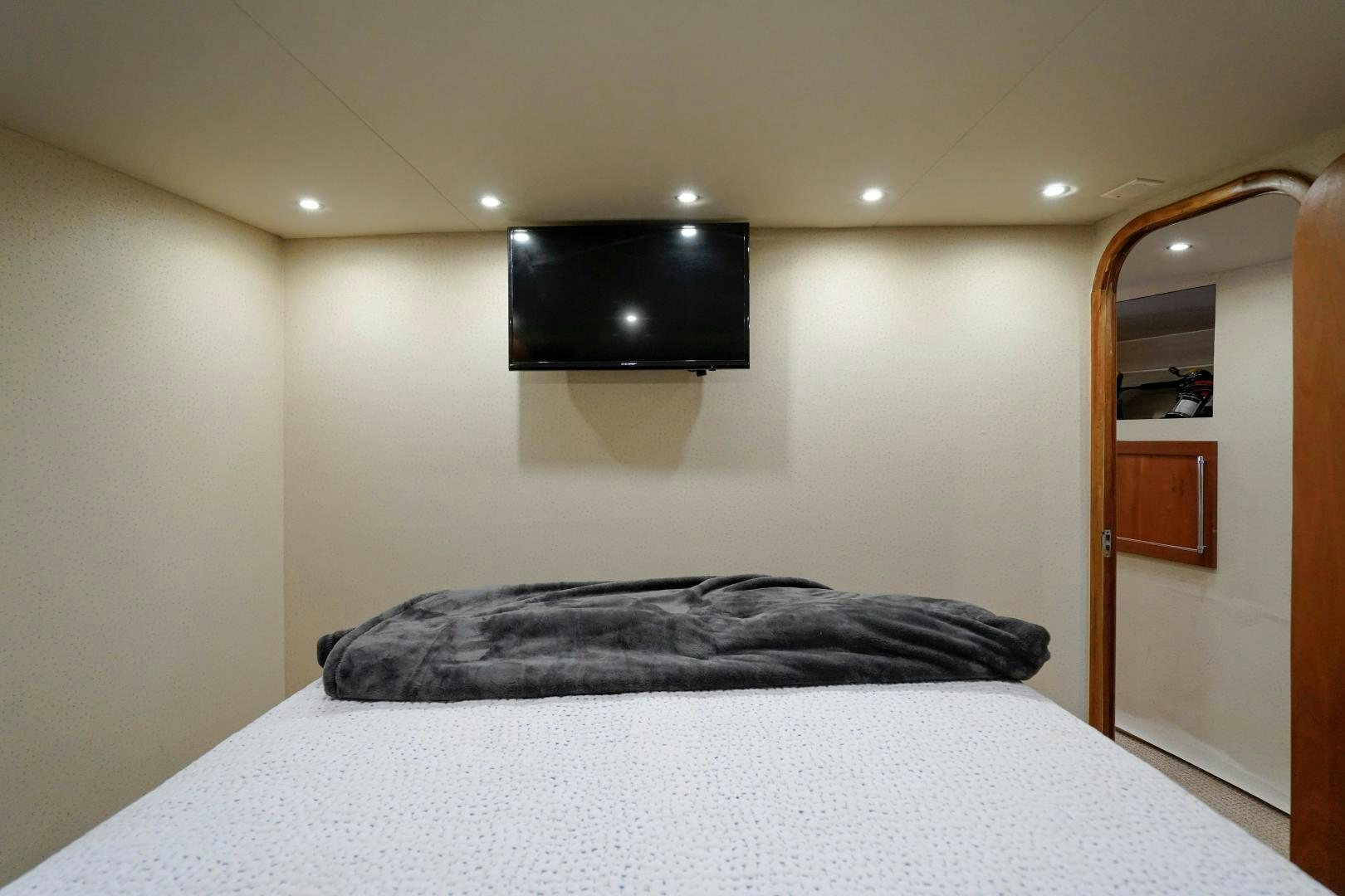 a bed with a black pillow aboard BIG ENOS Yacht for Sale