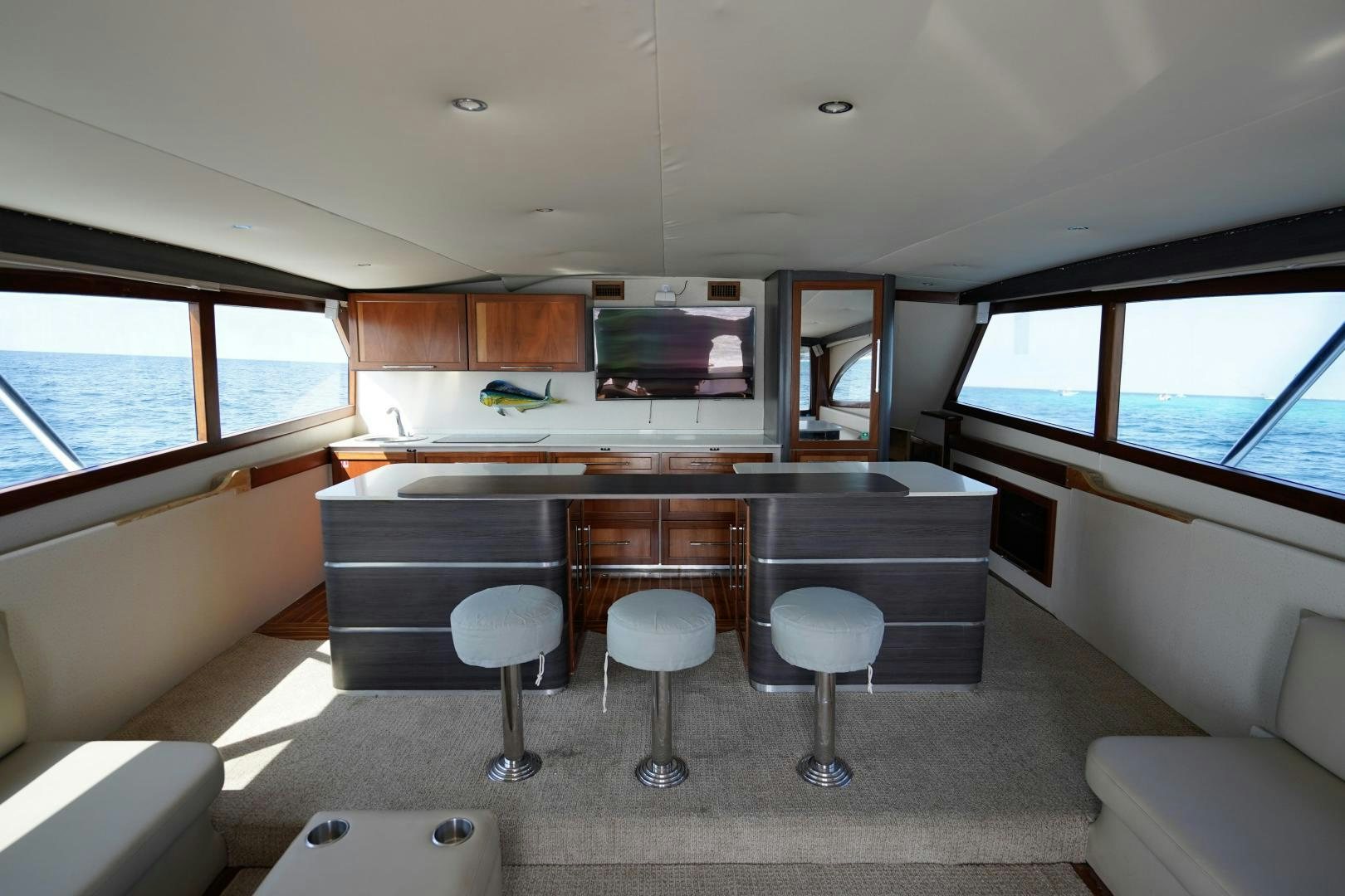 a room with a couch and a tv in it aboard BIG ENOS Yacht for Sale