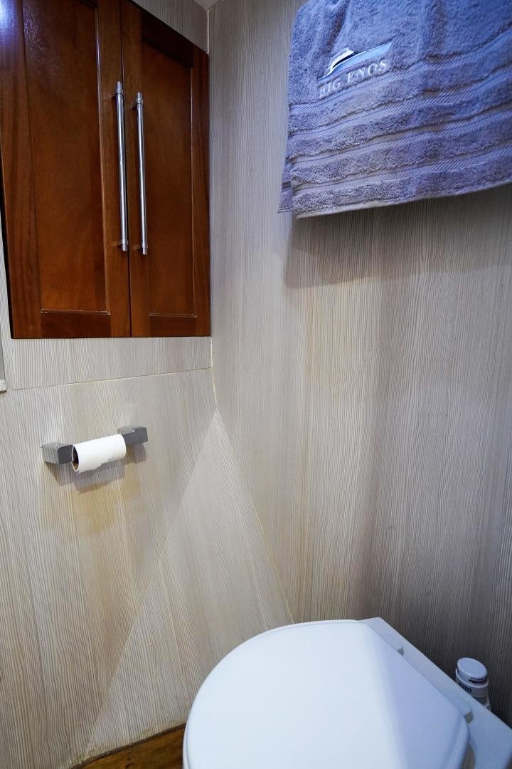 a bathroom with a towel on the wall aboard BIG ENOS Yacht for Sale