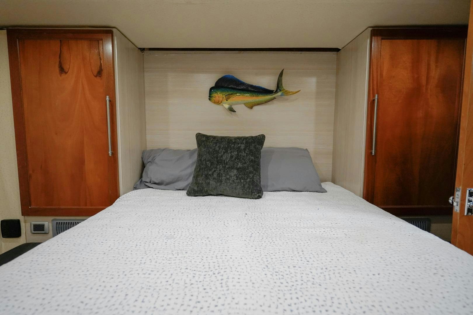 a bed with a white sheet and pillows aboard BIG ENOS Yacht for Sale