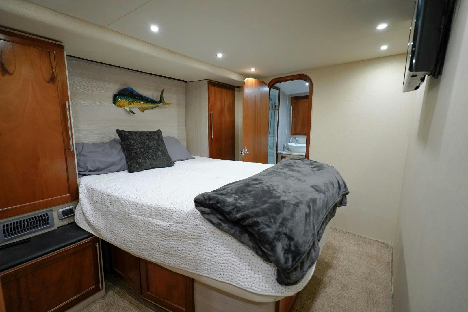 a bedroom with a bed and a mirror aboard BIG ENOS Yacht for Sale