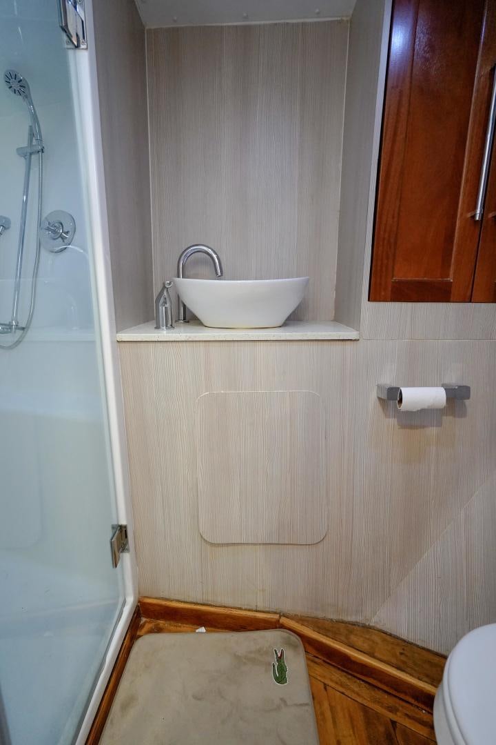 a bathroom with a sink and a toilet aboard BIG ENOS Yacht for Sale