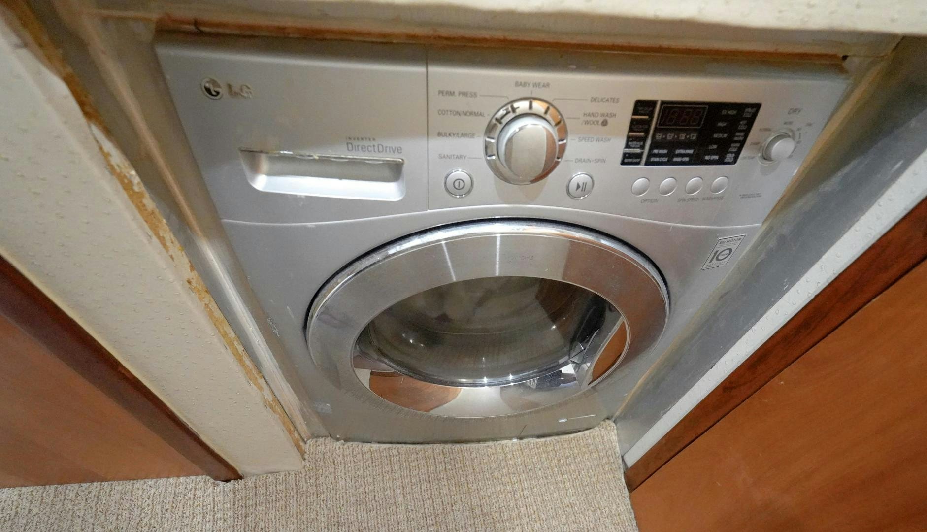 a white washing machine aboard BIG ENOS Yacht for Sale