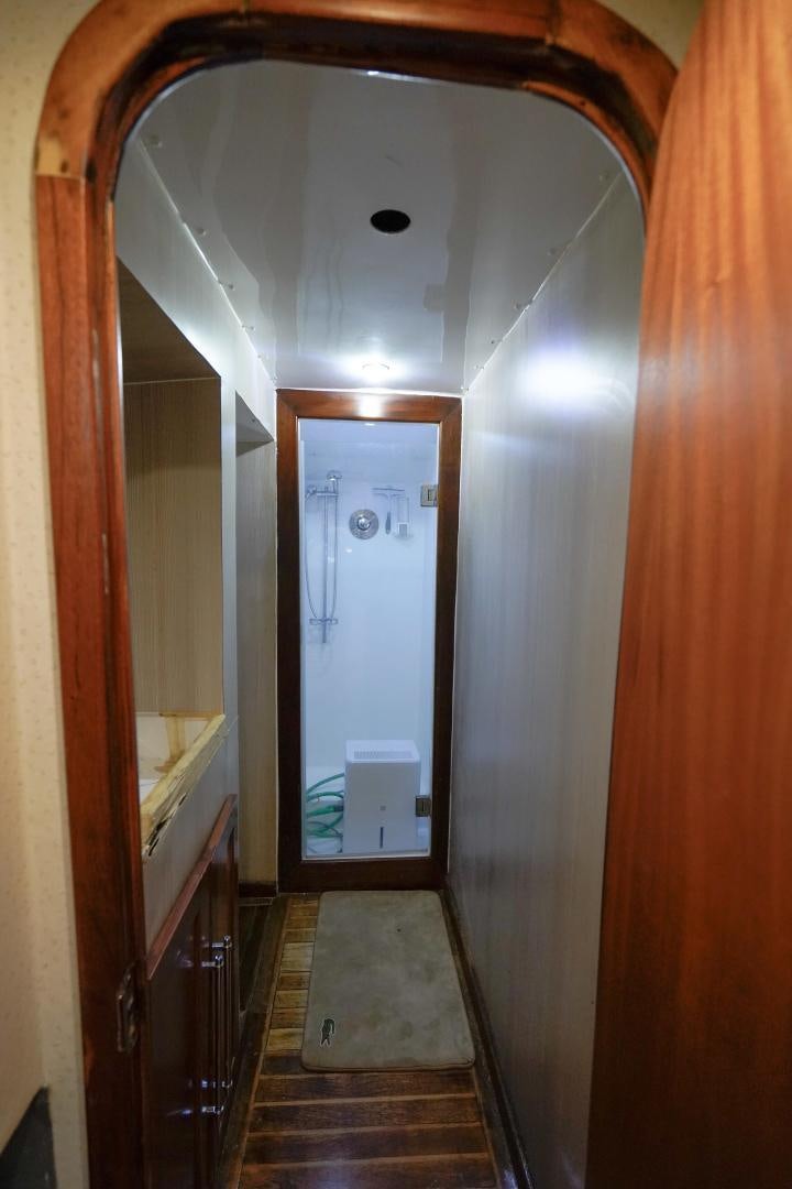 a hallway with a mirror and a door aboard BIG ENOS Yacht for Sale