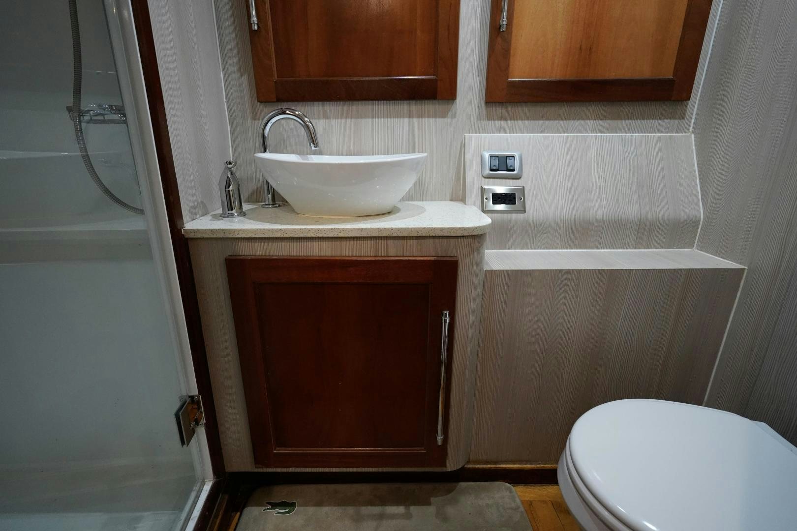 a bathroom with a sink and toilet aboard BIG ENOS Yacht for Sale