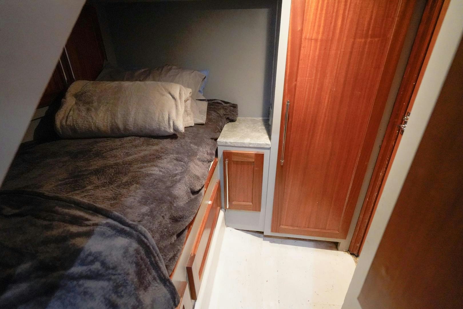 a bed with a pillow aboard BIG ENOS Yacht for Sale