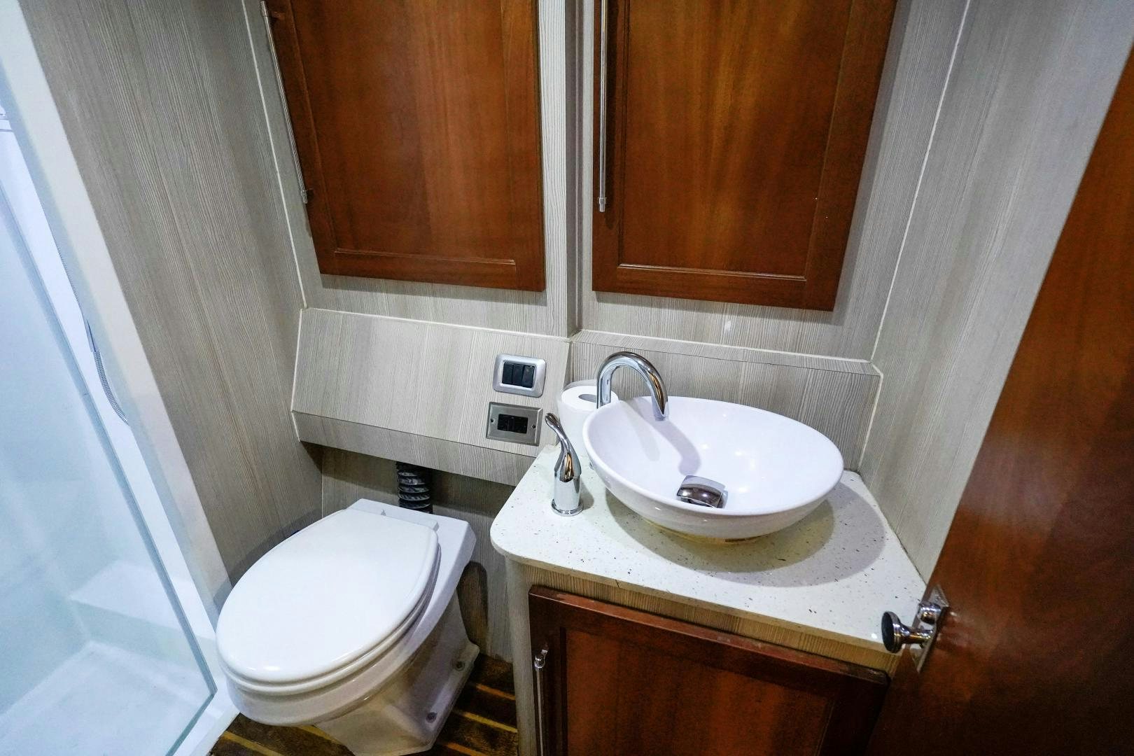 a bathroom with a sink and toilet aboard BIG ENOS Yacht for Sale