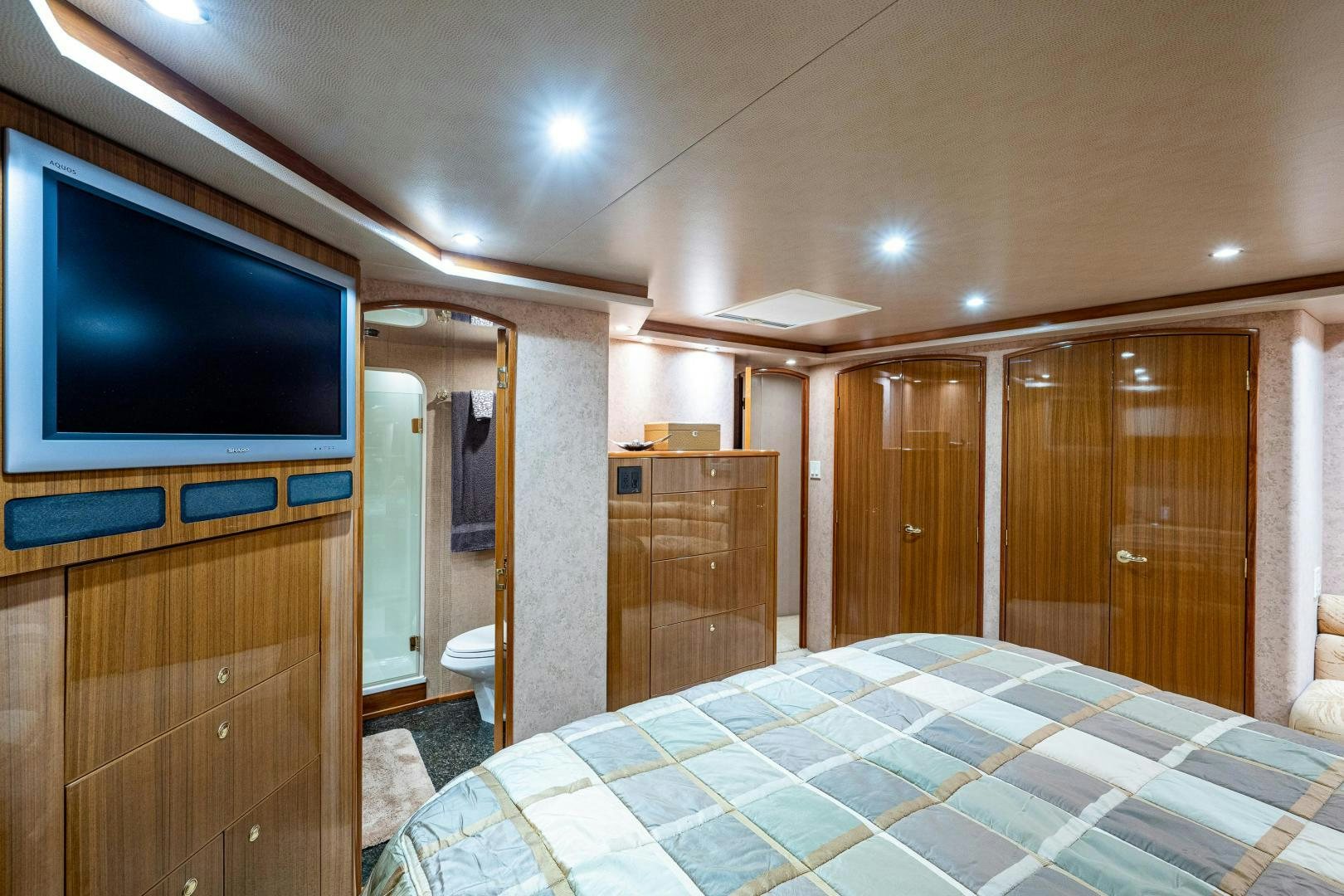 a bedroom with a large tv aboard REEL ESTATE Yacht for Sale
