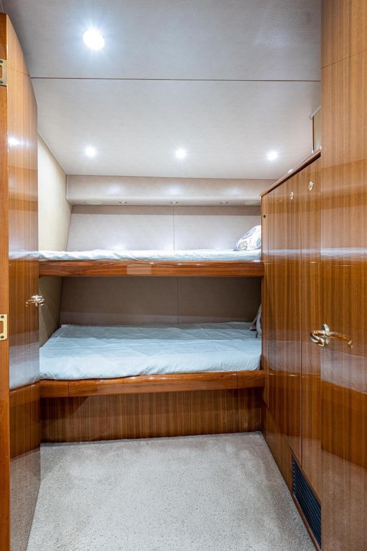 a room with a bed and a wood door aboard REEL ESTATE Yacht for Sale