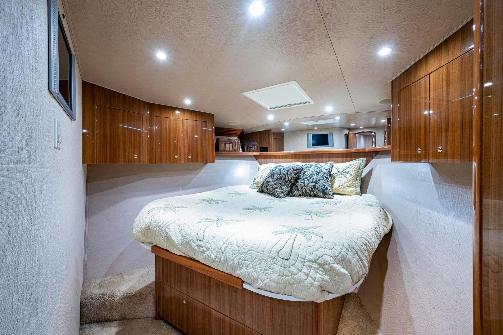 a bedroom with wood cabinets aboard REEL ESTATE Yacht for Sale