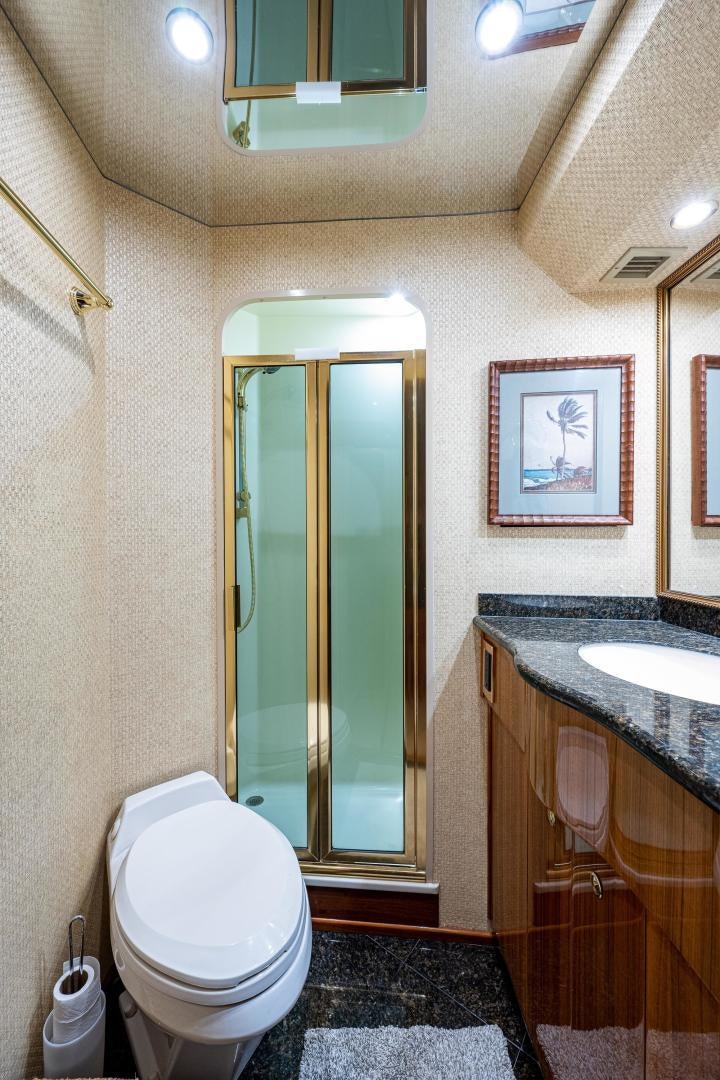 a bathroom with a glass shower door aboard REEL ESTATE Yacht for Sale