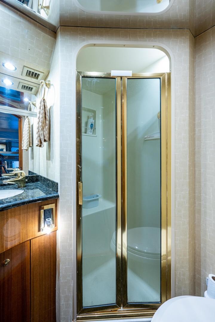 a bathroom with a glass shower aboard REEL ESTATE Yacht for Sale