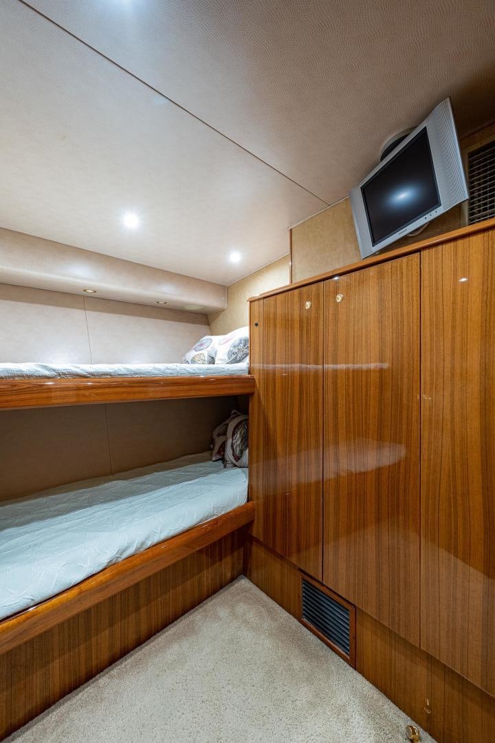 a room with a bed and a television aboard REEL ESTATE Yacht for Sale