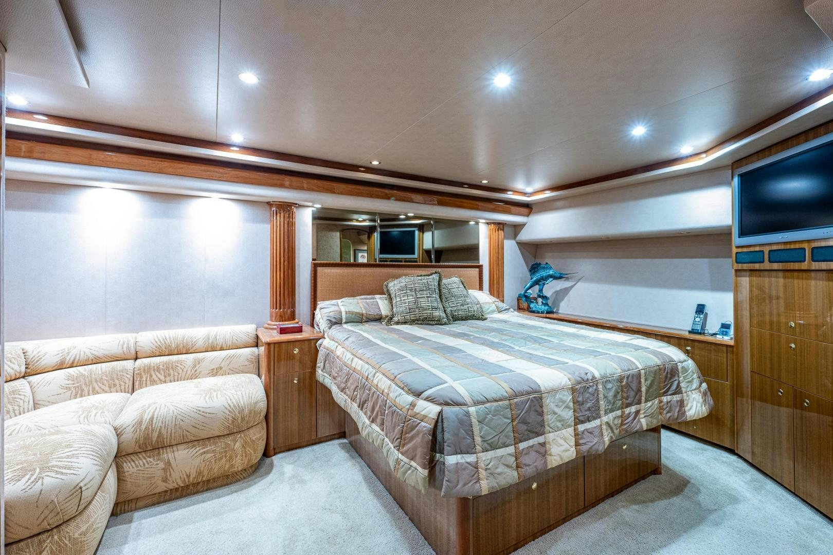 a bedroom with a bed and a couch aboard REEL ESTATE Yacht for Sale