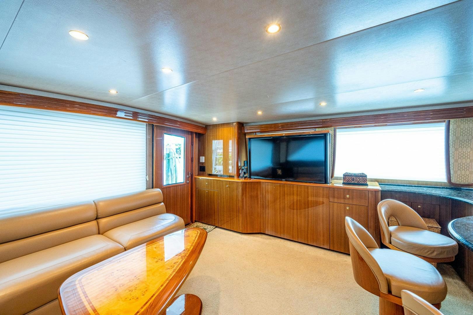 a living room with a couch and a television aboard REEL ESTATE Yacht for Sale