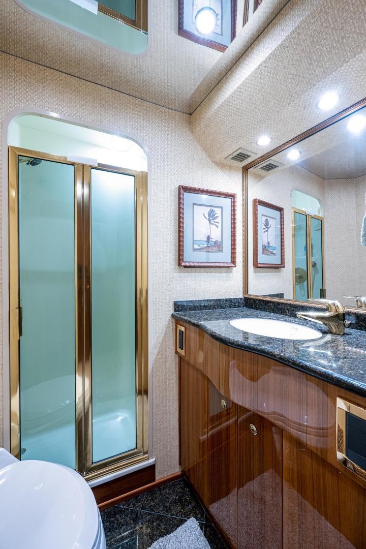 a bathroom with a glass shower aboard REEL ESTATE Yacht for Sale