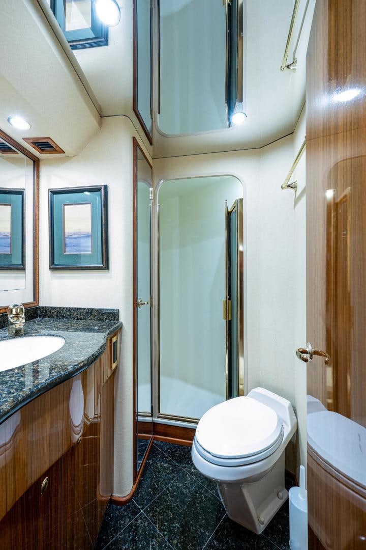 a bathroom with a toilet and a sink aboard REEL ESTATE Yacht for Sale