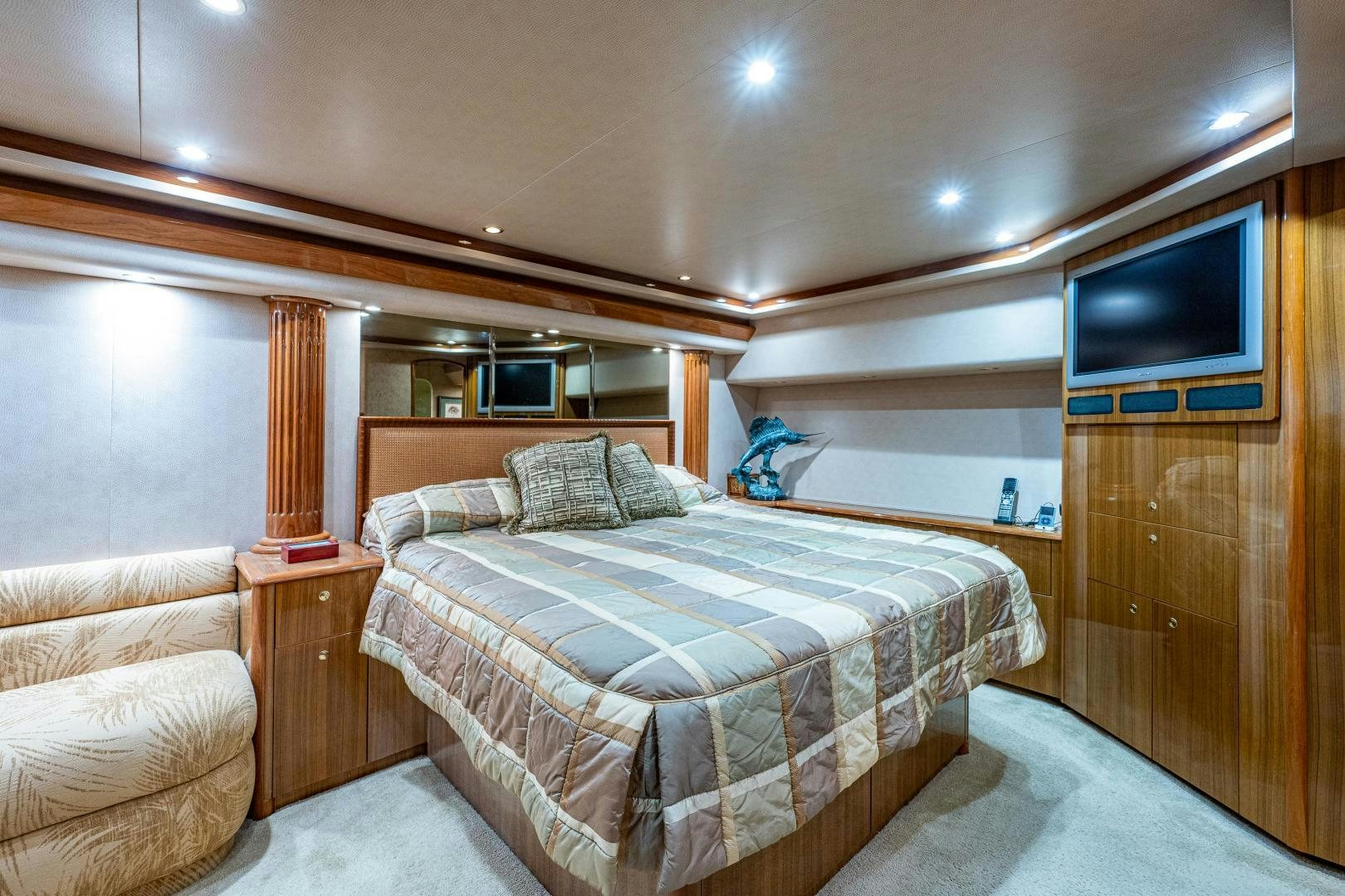a bedroom with a bed and a television aboard REEL ESTATE Yacht for Sale