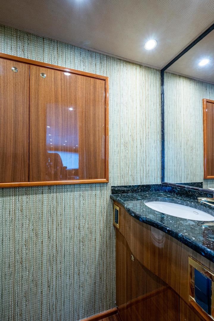 a bathroom with a sink and cabinets aboard REEL ESTATE Yacht for Sale
