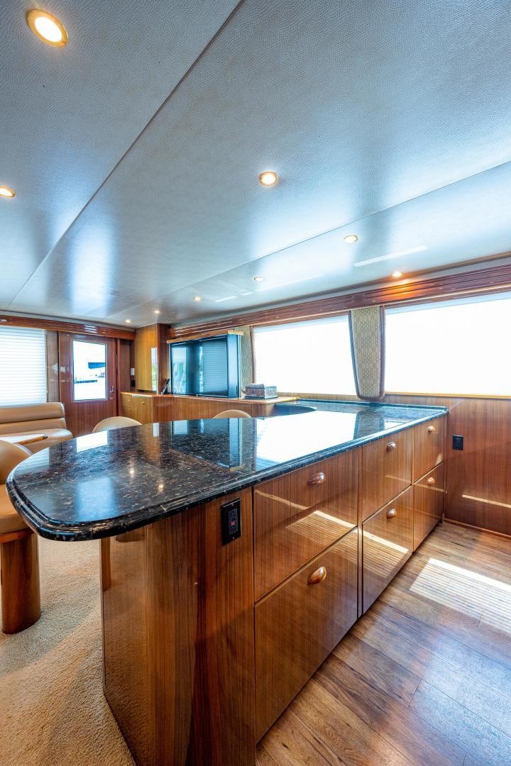 a kitchen with a large island aboard REEL ESTATE Yacht for Sale