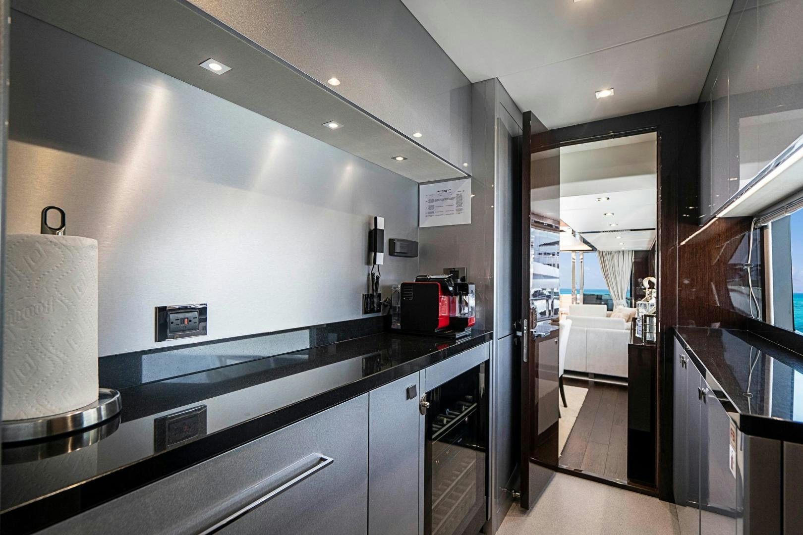 a kitchen with black counter tops aboard QUANTUM Yacht for Sale
