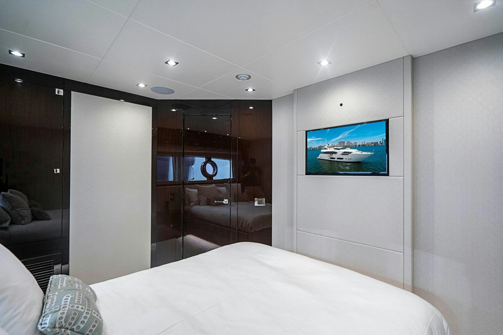 a hotel room with a bed and tv aboard QUANTUM Yacht for Sale