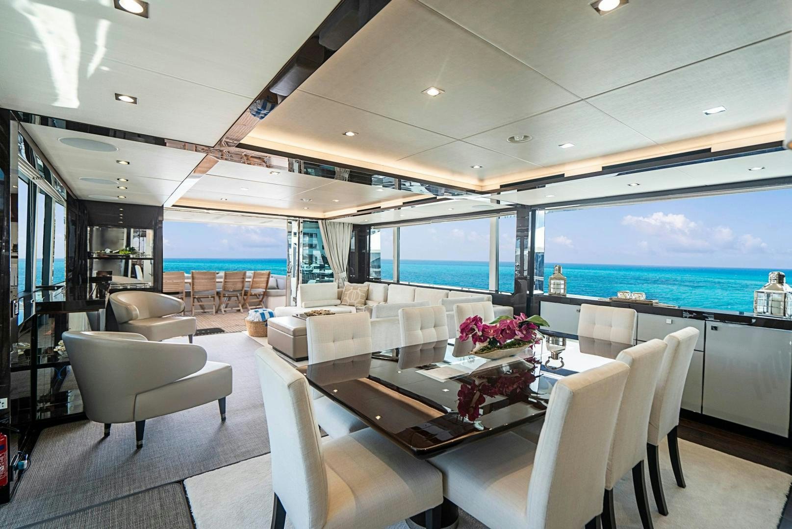 a room with a large table and chairs and a large window aboard QUANTUM Yacht for Sale